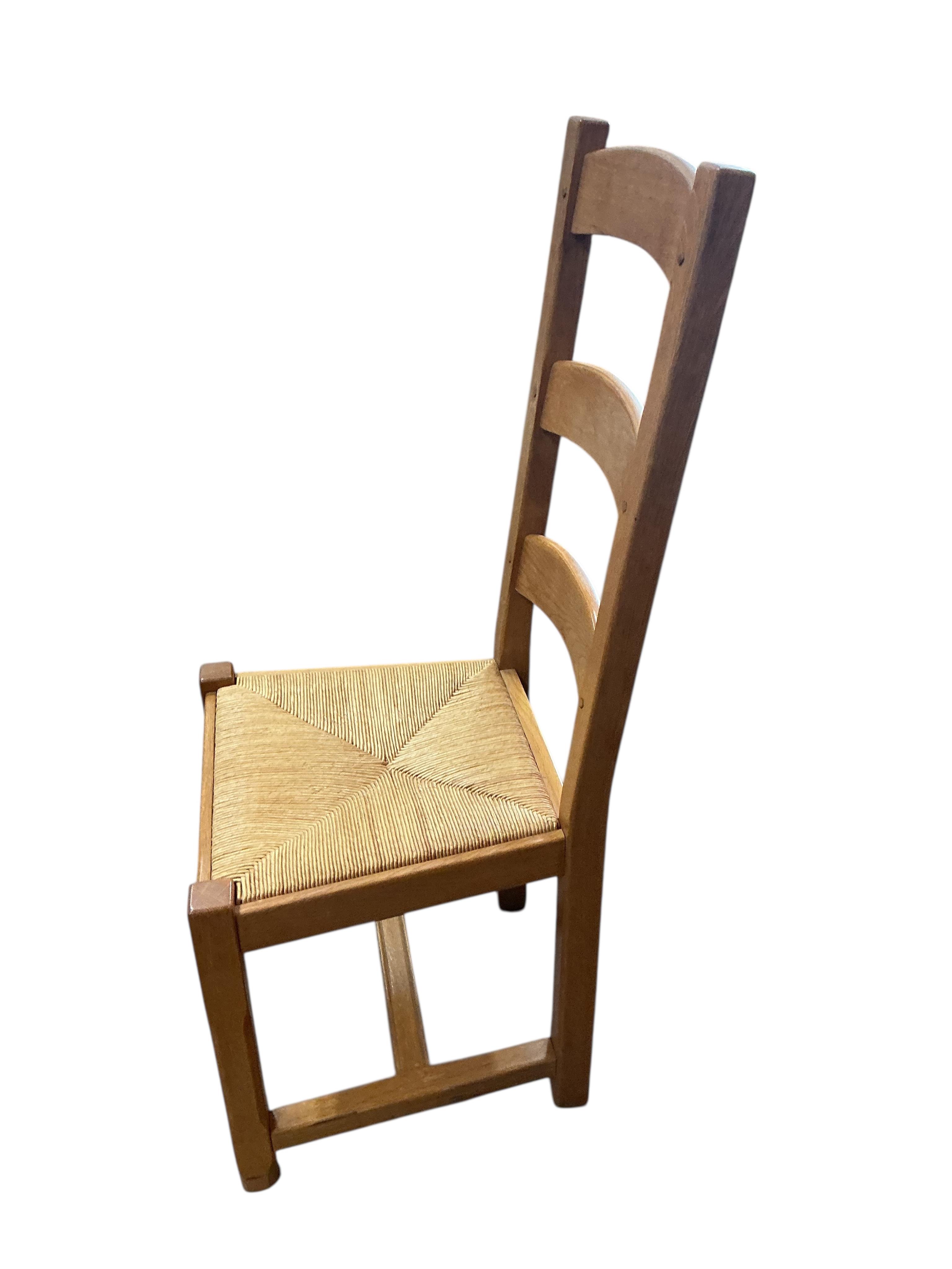 A set of eight contemporary oak rush seat ladderback dining chairs
